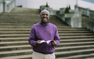 Portrait of Victor holding a Kinyamulenge Bible