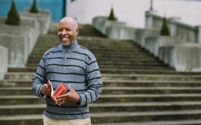 Portrait of Tito holding Kinyamulenge Scripture