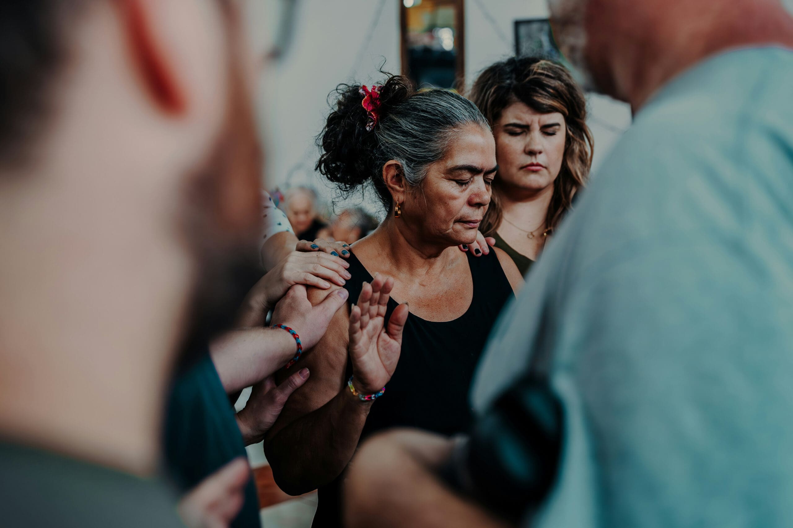 A group of people hold up their green bibles